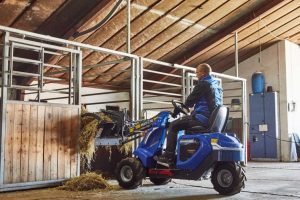 MultiOne mini loader 1 series with silage fork moving hay in a horse stable