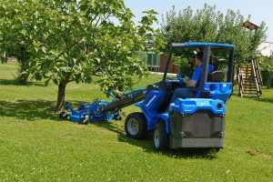 MultiOne mini loader 6 series with lawn mower in a garden