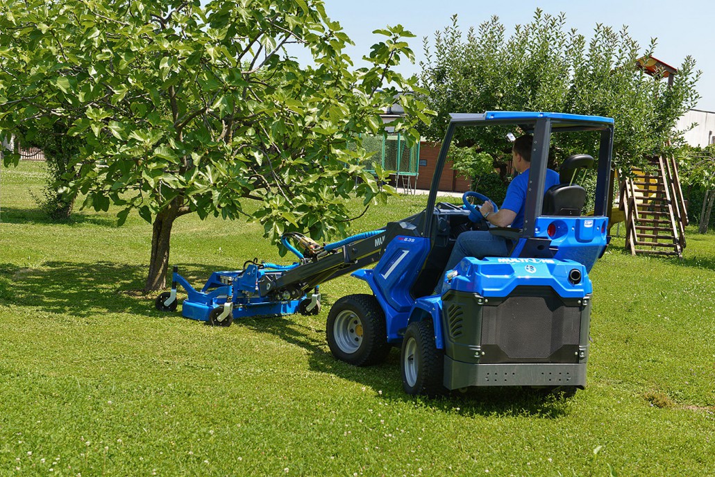 MultiOne mini loader 6 series with lawn mower in a garden