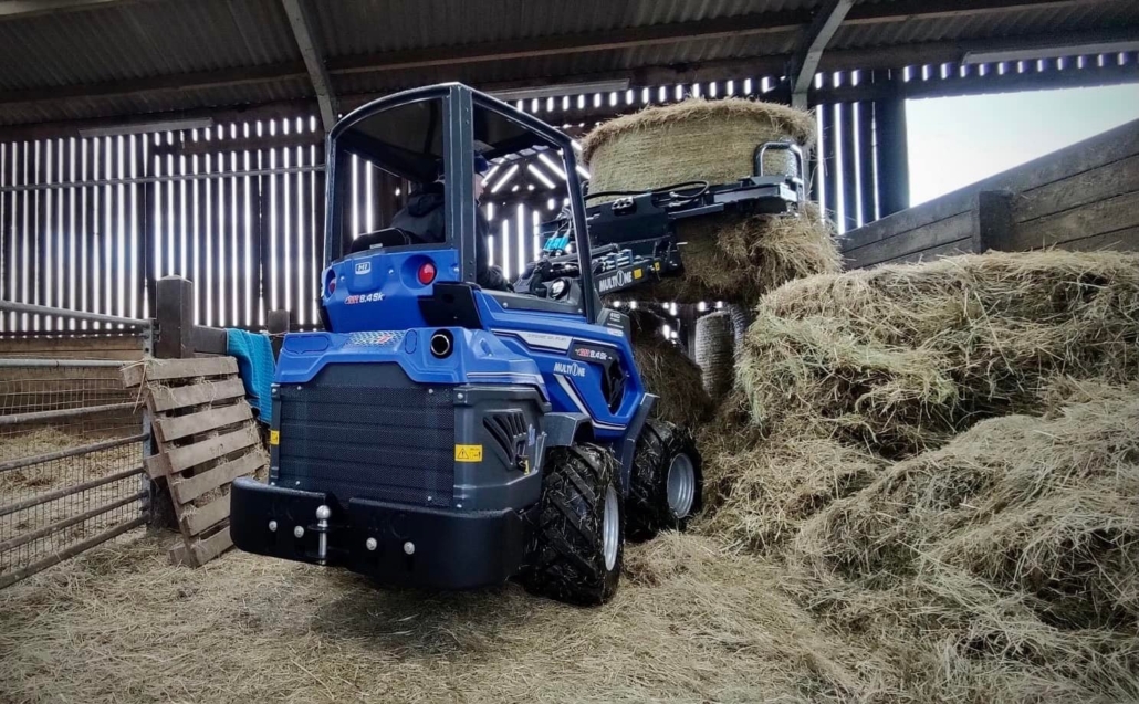 MultiOne mini loader 8.4 series 01 lifting a hay bale