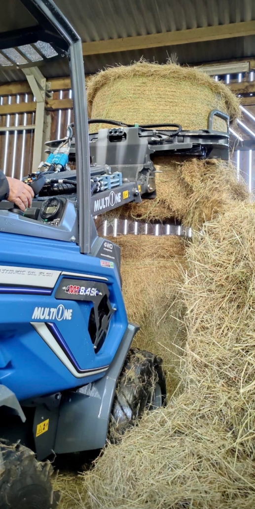 MultiOne mini loader 8.4 series 04 lifting a hay bale