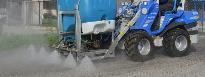 detail of a street washer cleaning concrete