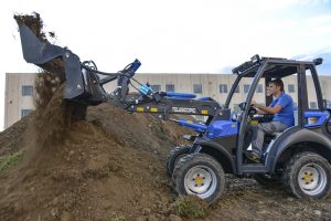combo bucket on a little soil mountain