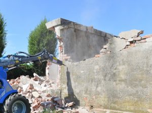 detail of an hydraulic breaker demolishing a wall
