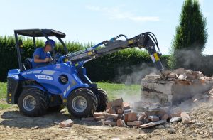 hydraulic breaker working o a tiles wall