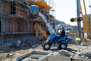 man using a multione cement mixer while working in a construction site