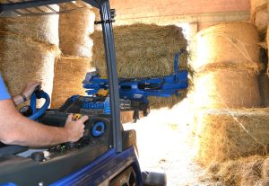 bale grabber moving a hay bale seen from the cabin point of view