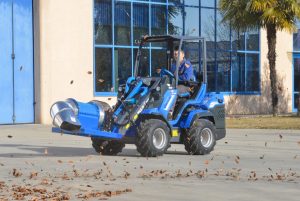 man using a debris and leaf blower to move leaves