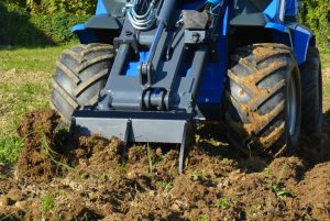 detail of the front of a ripper moving soil