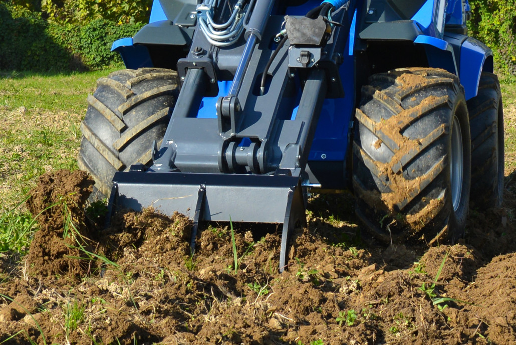 detail of the front of a ripper moving soil
