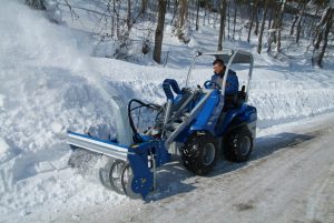 snow blower in action seen from afar