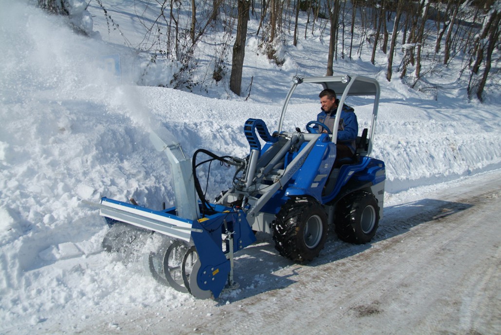 snow blower in action seen from afar