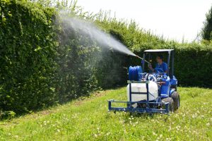 sprayer in action on a bush