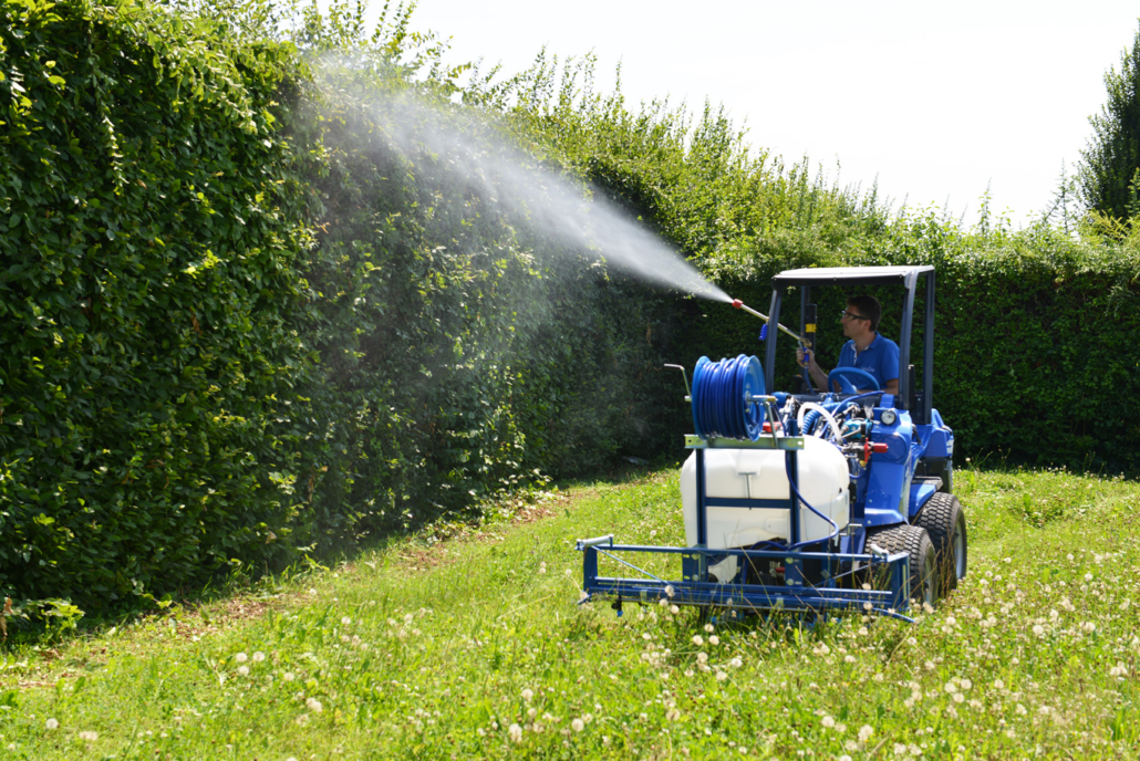 sprayer in action on a bush