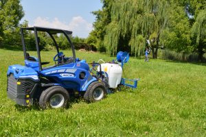 sprayer in action on a grass field